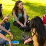 students sitting in a circle in playground