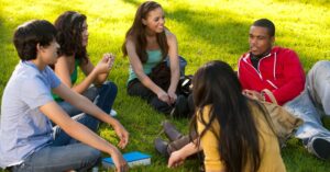 students sitting in a circle in playground