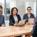 a student sitting in a college interview in front of teachers