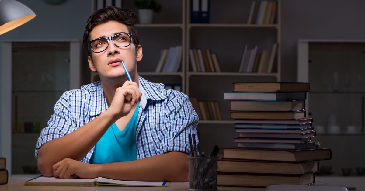 a boy in blue shirt thinking about writing the first line of the essay