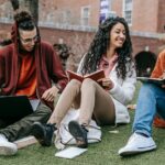 students sitting and holding books in hand