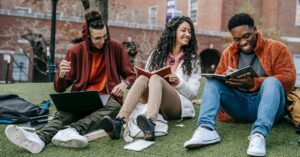 students sitting and holding books in hand