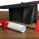 college degree and book on a table