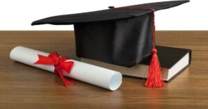 college degree and book on a table