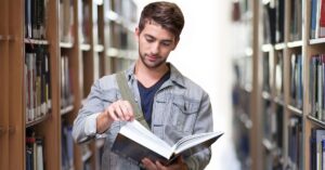 a boy reading book in the library