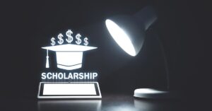 a lamp focuses on a scholarship word