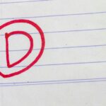 D grade written on paper