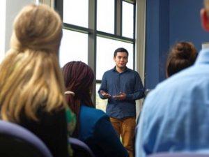 teacher communicating with students in classroom