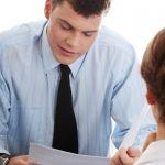 man looking at papers of applicant