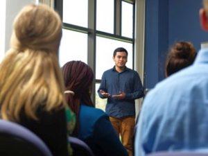 a teacher communicating with students in a classroom