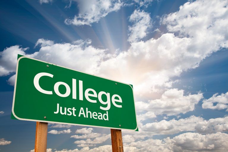 A street sign that says " College Just Ahead"