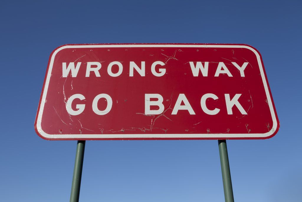 wrong way go back sign board