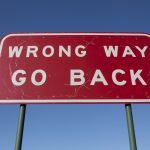 wrong way go back sign board