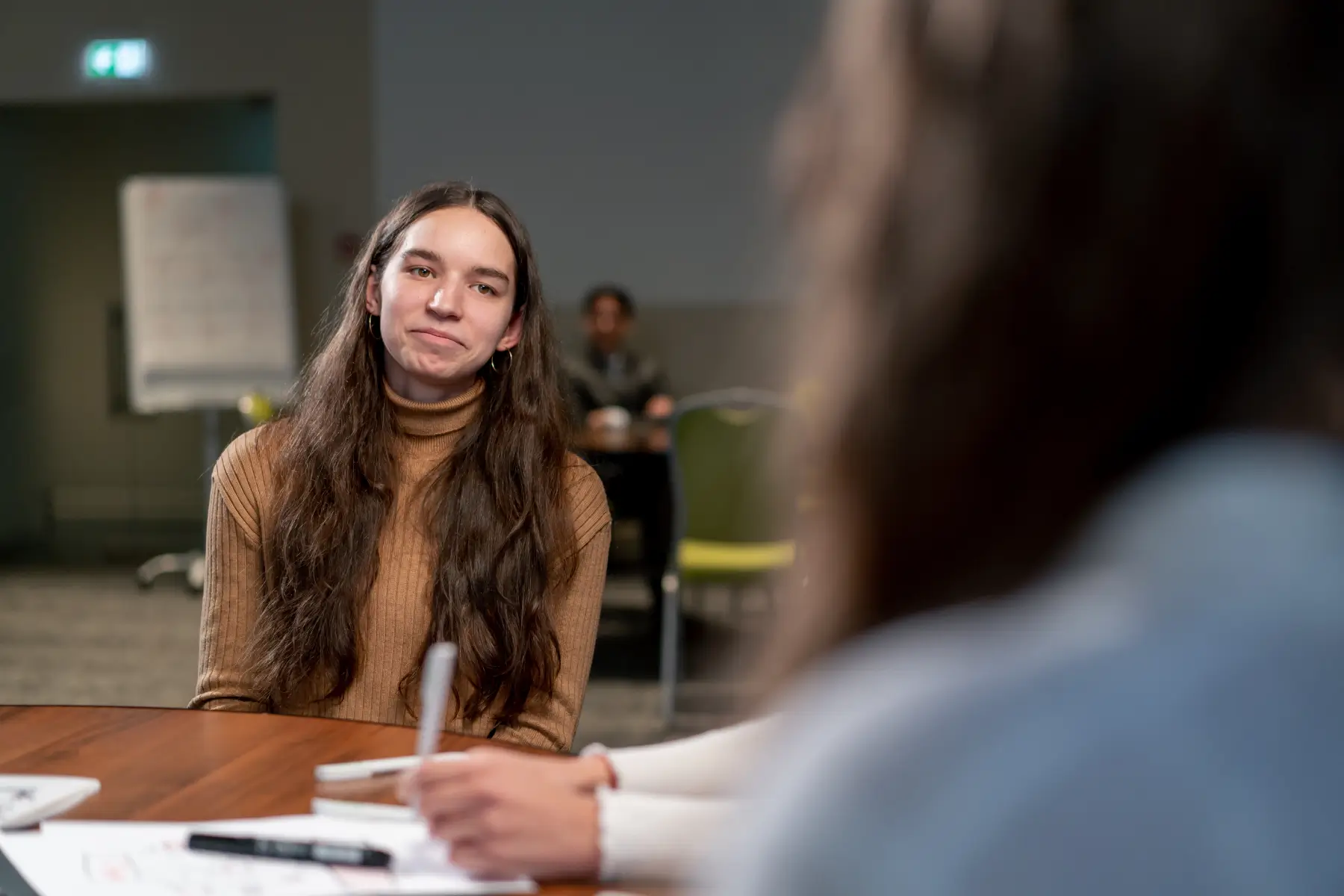 smiling-girl-talks-about-herself-at-an-interview