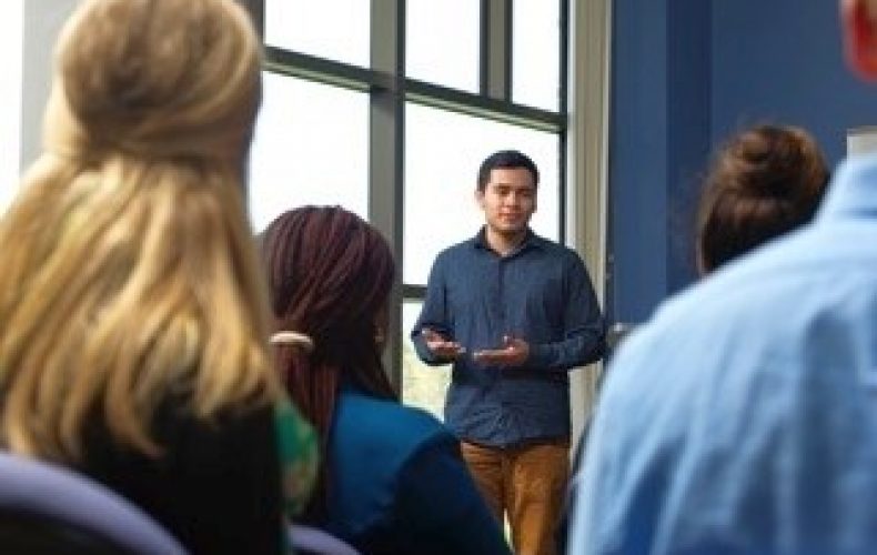 a teacher communicating with students in a classroom