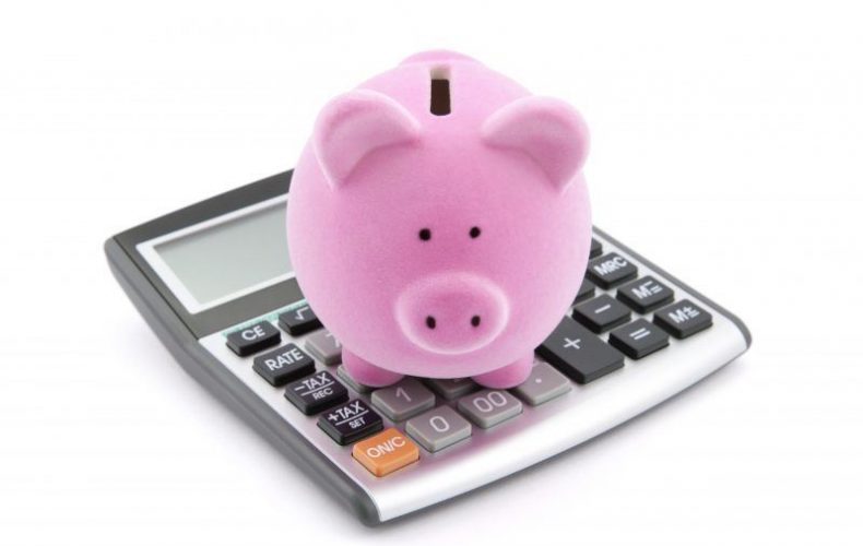 pink color piggi bank on a calculator