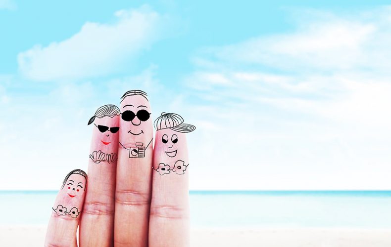 fingers with faces on it at the beach