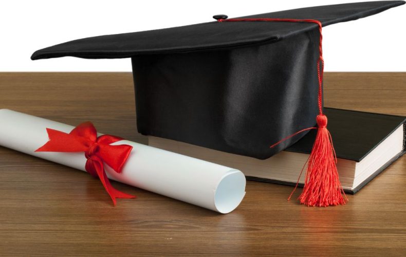 college degree and book on a table