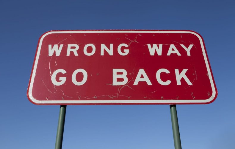 wrong way go back sign board