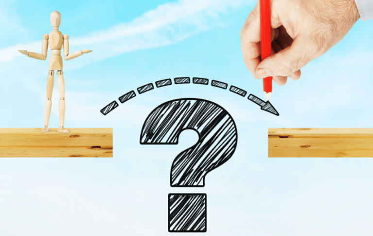 A hand draws an arrow over a large question mark between two wooden planks, with a wooden mannequin standing on one plank, symbolizing decision-making or finding solutions to bridge a gap.